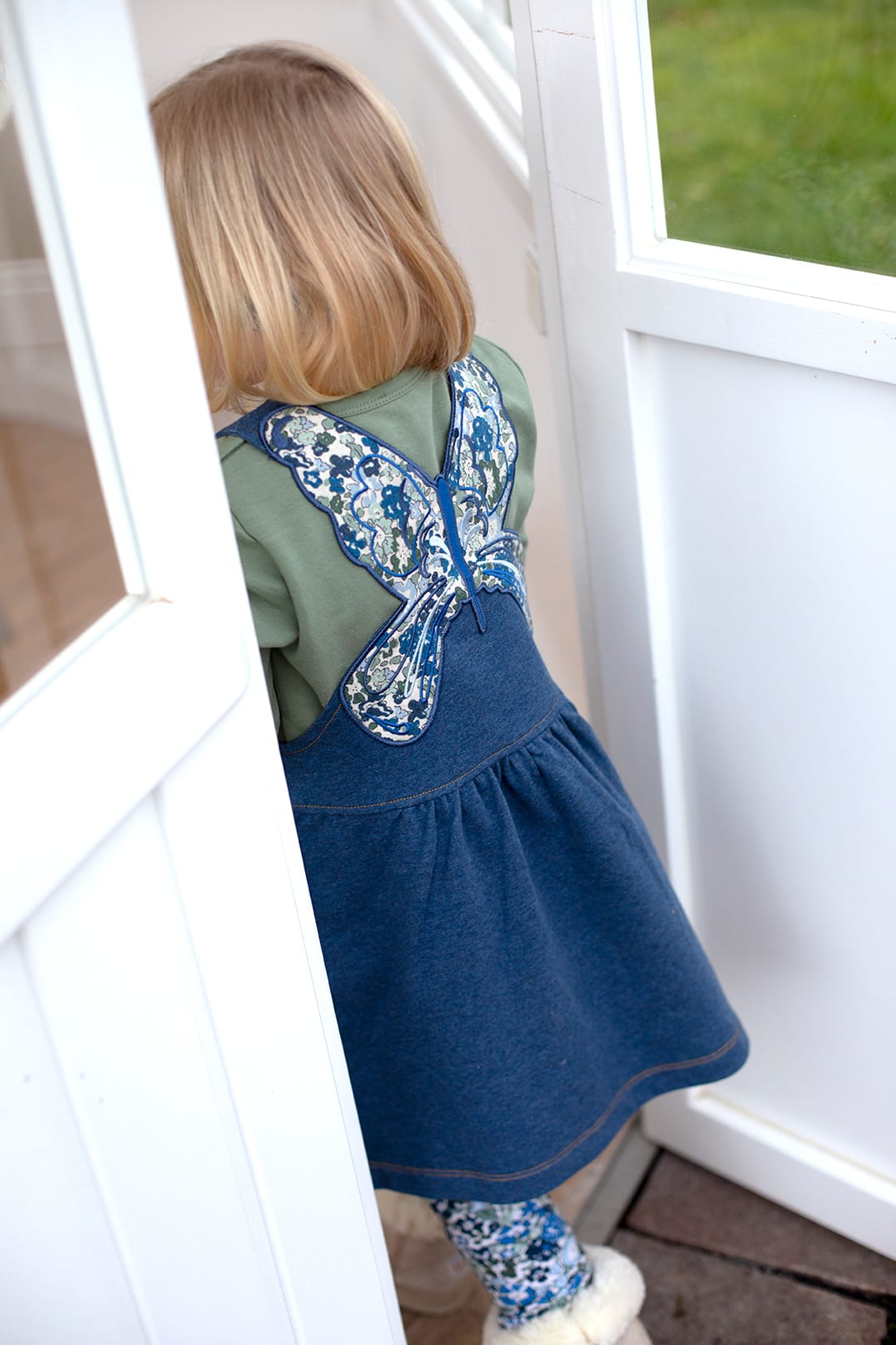Denim blue pinafore dress with butterfly appliqué